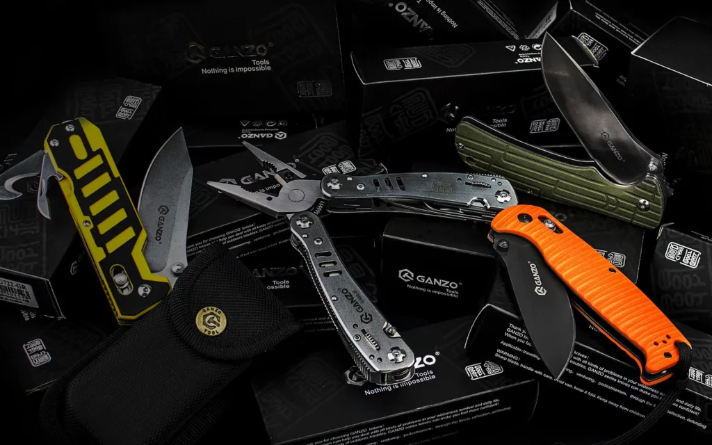 Ganzo survival multitools and folding knives on black boxes, pliers, blades and carry pouch for outdoor trips and camping
